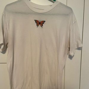 White t-shirt with orange and yellow butterfly